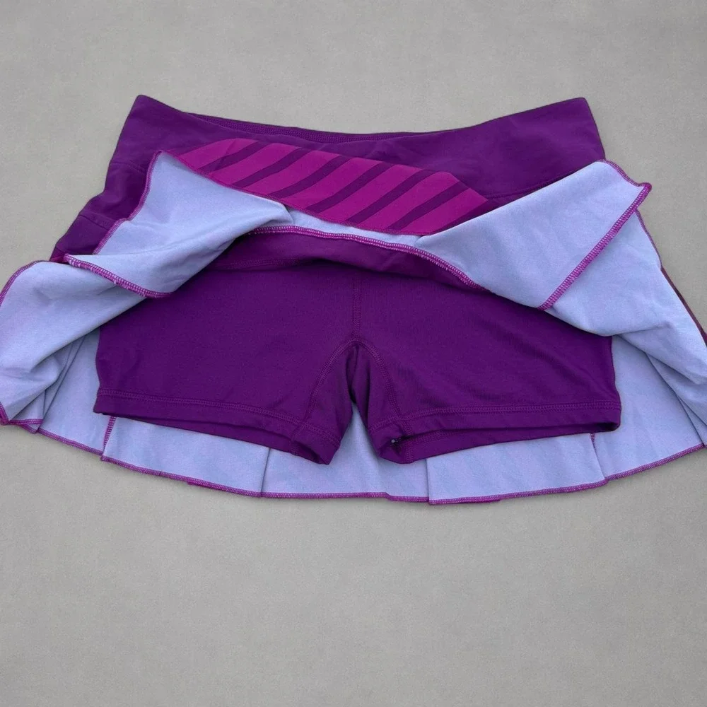 Nike purple tennis skort with diagonal stripes in shades of purple, size M